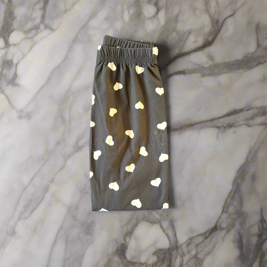 Black leggings with white hearts design